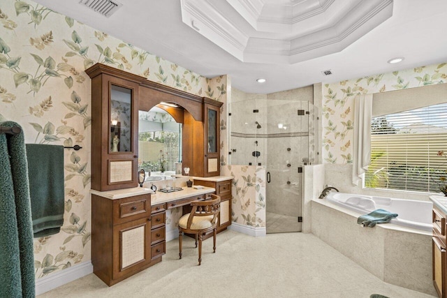 bathroom with a tray ceiling, ornamental molding, and separate shower and tub