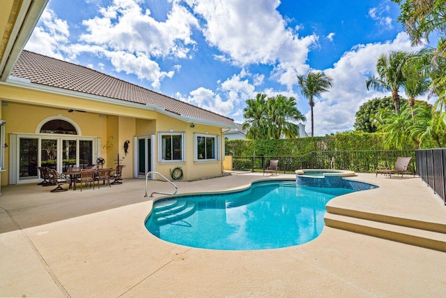 view of pool featuring an in ground hot tub and a patio