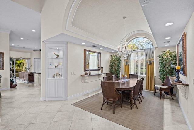 tiled dining space featuring plenty of natural light, a notable chandelier, and a textured ceiling