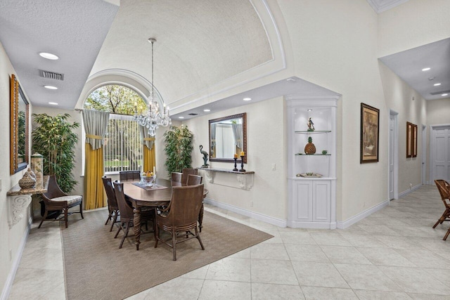 dining space with a notable chandelier, a towering ceiling, a textured ceiling, and light tile patterned floors