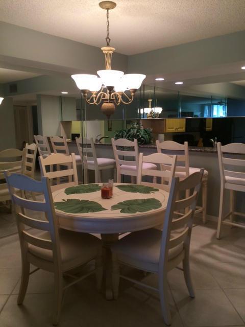 2461 Village Blvd Unit 101, West Palm Beach, FL 33409 - kitchen with freestanding refrigerator and light tile patterned floors