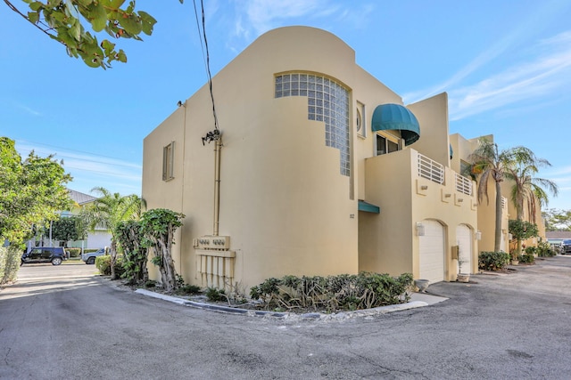 3213 NE 16th St Unit 112, Pompano Beach, FL 33062 - view of building exterior with a garage