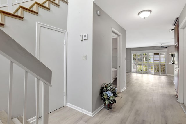 corridor with light hardwood / wood-style flooring