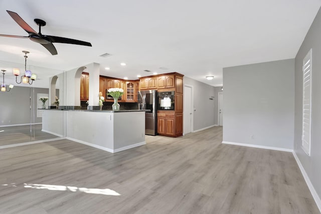 kitchen featuring stainless steel fridge with ice dispenser, hanging light fixtures, light wood-type flooring, kitchen peninsula, and oven