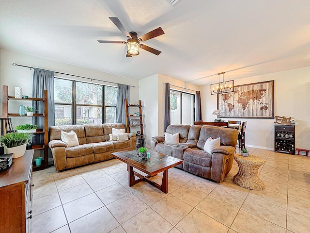 tiled living room with a healthy amount of sunlight, ceiling fan with notable chandelier, and a textured ceiling