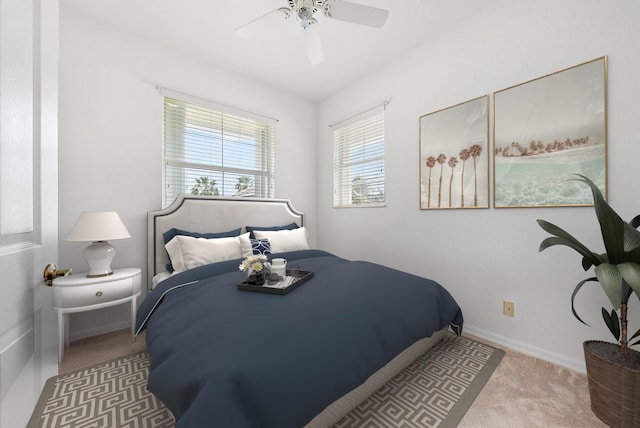 carpeted bedroom featuring ceiling fan and baseboards