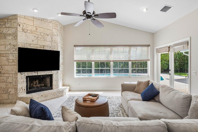 tiled living area featuring a ceiling fan, lofted ceiling, visible vents, and a fireplace