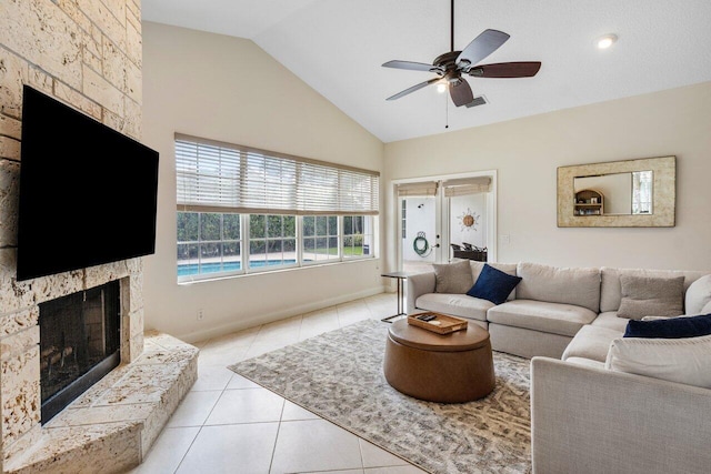 living area featuring light tile patterned floors, ceiling fan, high vaulted ceiling, a fireplace, and visible vents