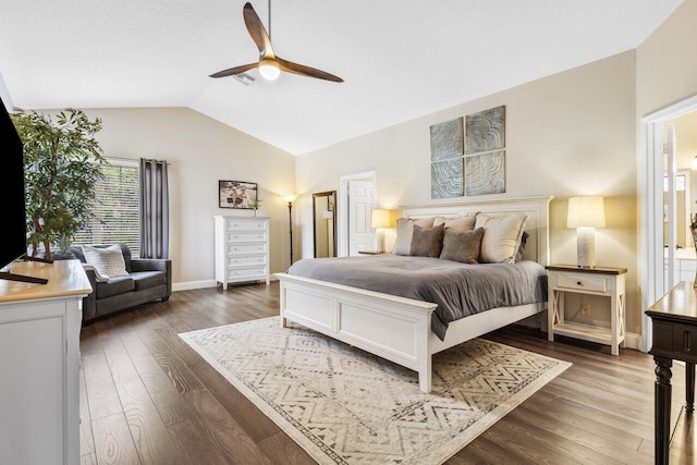 bedroom with baseboards, visible vents, a ceiling fan, dark wood finished floors, and vaulted ceiling