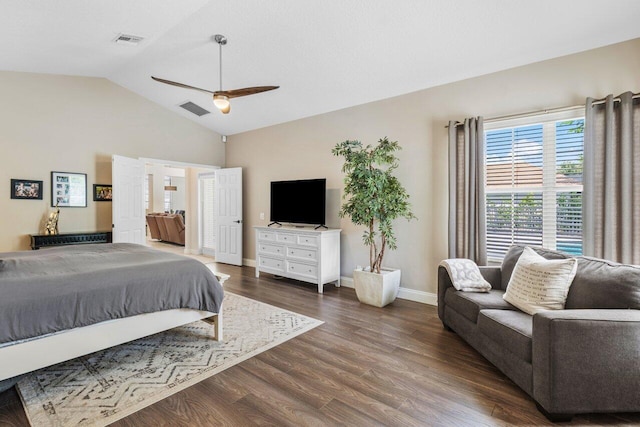 bedroom with lofted ceiling, dark wood finished floors, visible vents, and baseboards