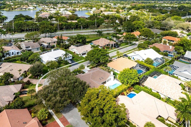 drone / aerial view with a residential view and a water view