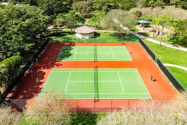 view of tennis court with a gazebo, a lawn, and fence