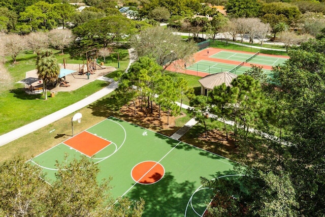 view of basketball court featuring community basketball court, fence, and a lawn