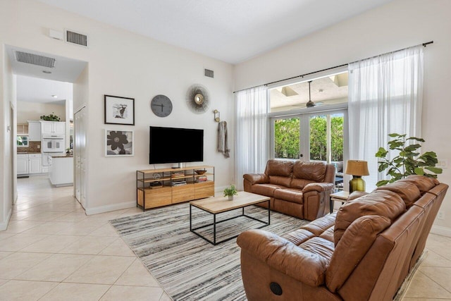 living room featuring baseboards, visible vents, and light tile patterned flooring