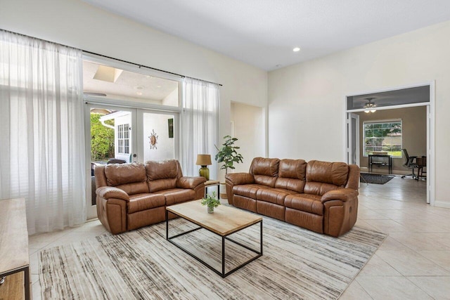 living area with light tile patterned floors, recessed lighting, and french doors