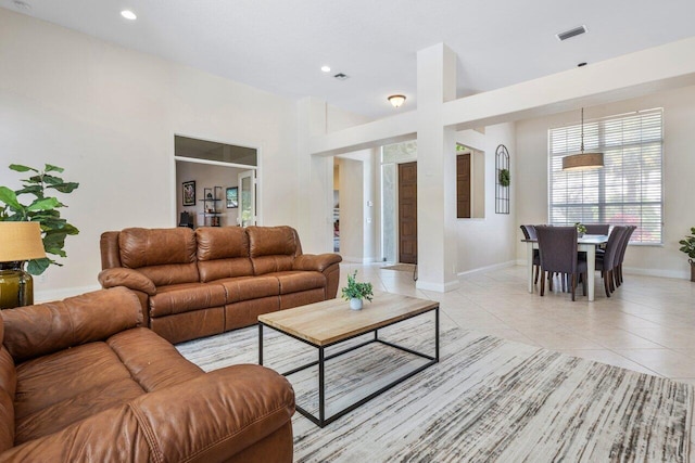 living room with recessed lighting, visible vents, baseboards, and light tile patterned floors