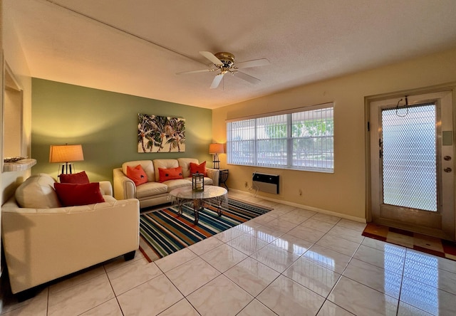 living room featuring ceiling fan, light tile patterned flooring, and baseboards