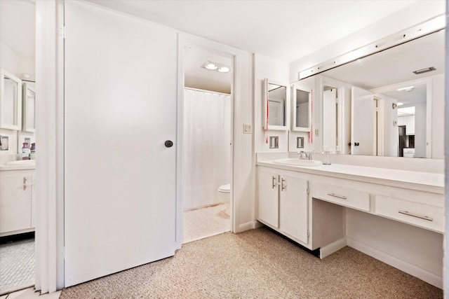 bathroom featuring vanity, toilet, and a shower with shower curtain