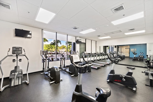 exercise room featuring a drop ceiling