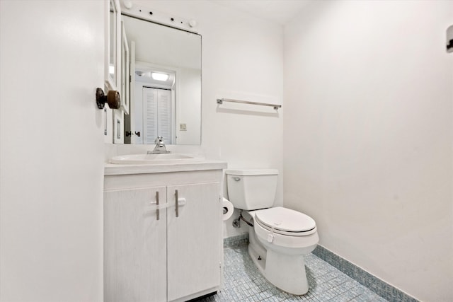 bathroom featuring tile patterned flooring, vanity, and toilet