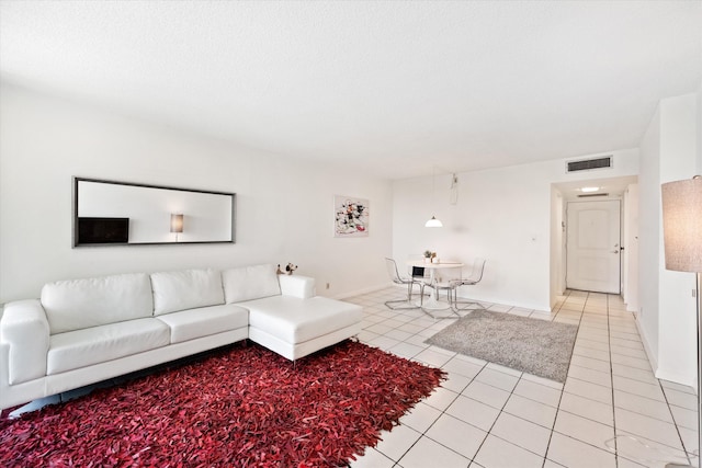 unfurnished living room featuring light tile patterned floors