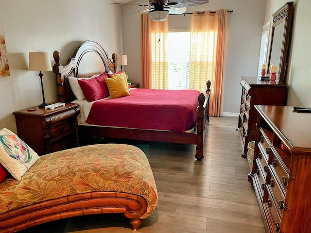 bedroom with ceiling fan and light wood-type flooring