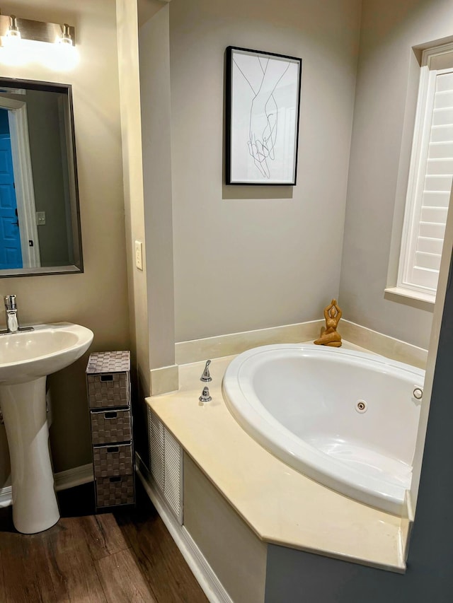 bathroom featuring hardwood / wood-style flooring and a tub