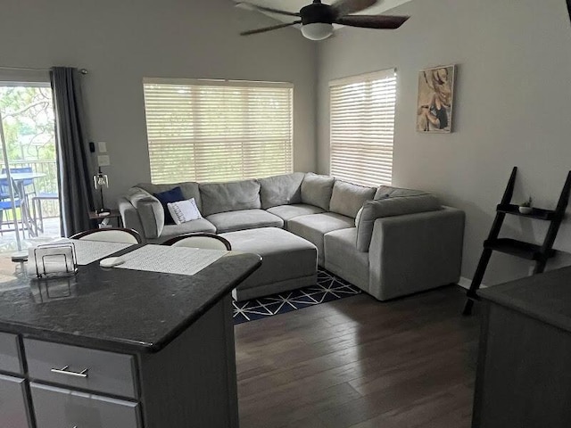 living room with dark hardwood / wood-style floors and ceiling fan