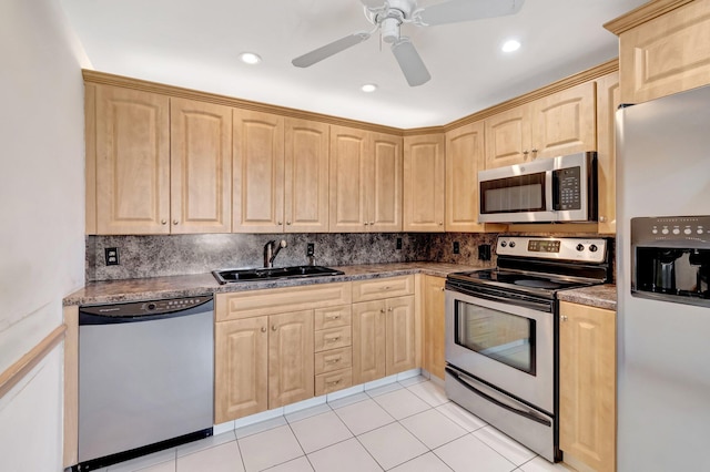 kitchen with stainless steel appliances, tasteful backsplash, sink, and light brown cabinetry