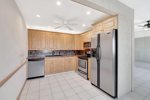 kitchen with appliances with stainless steel finishes, sink, light brown cabinets, and ceiling fan