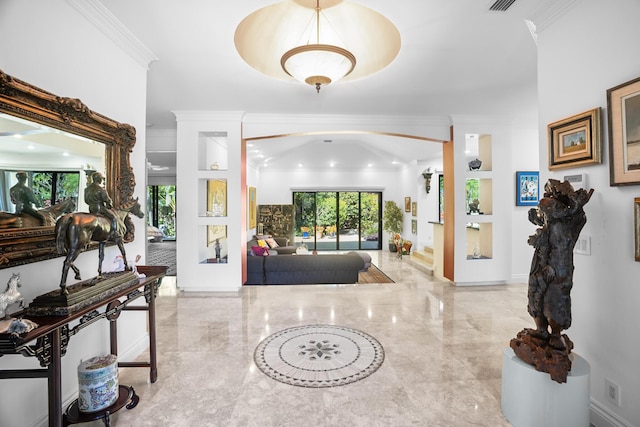 entryway featuring baseboards, marble finish floor, and crown molding