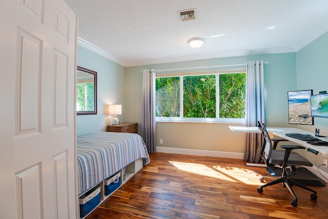 bedroom with multiple windows, ornamental molding, dark hardwood / wood-style floors, and a textured ceiling