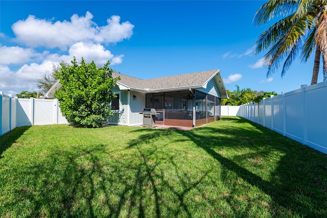 back of property featuring a yard and a sunroom