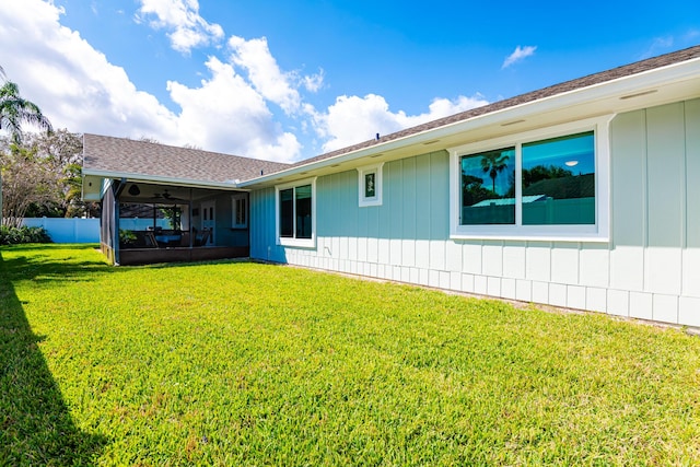 rear view of property featuring a lawn