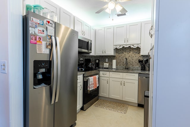 kitchen featuring stainless steel appliances, white cabinetry, and sink