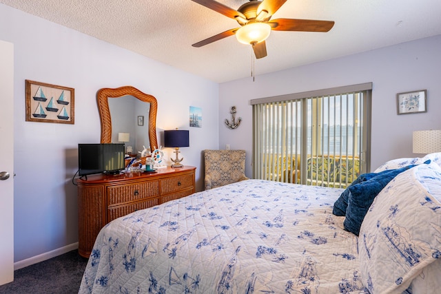 bedroom with ceiling fan, carpet, access to exterior, and a textured ceiling