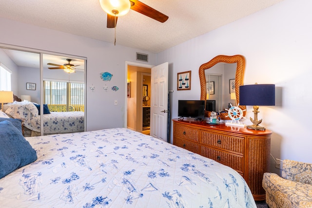 bedroom with ceiling fan, access to exterior, and a textured ceiling