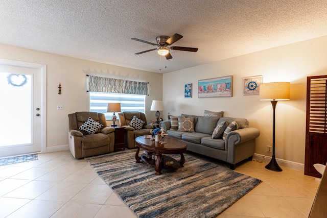 living room featuring light tile patterned flooring, a textured ceiling, and ceiling fan