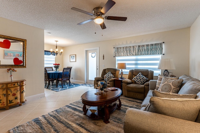 tiled living room featuring ceiling fan with notable chandelier and a textured ceiling