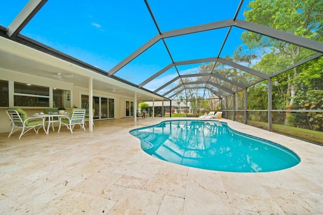 view of pool featuring a patio, ceiling fan, and glass enclosure