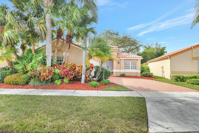 mediterranean / spanish home featuring a front yard