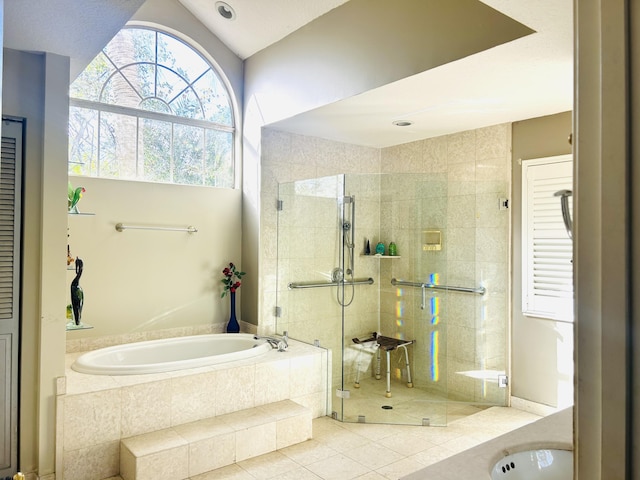 bathroom featuring tile patterned floors, lofted ceiling, and independent shower and bath