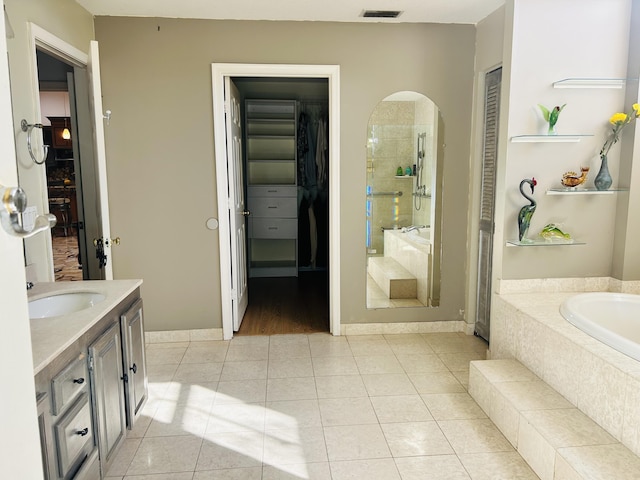 bathroom with an enclosed shower, vanity, and tile patterned flooring