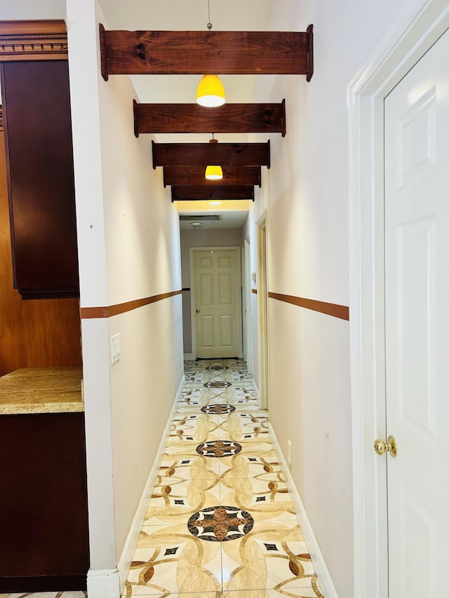 hallway featuring light tile patterned floors and beamed ceiling