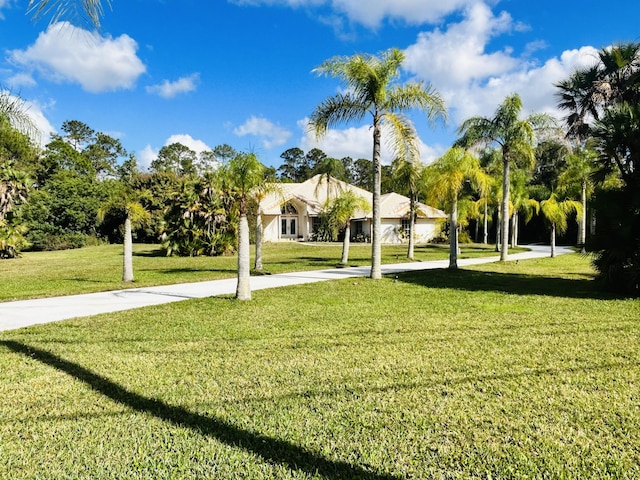 view of property's community with a lawn