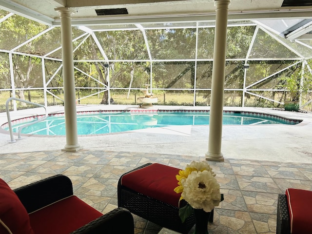 view of pool with a patio and a lanai