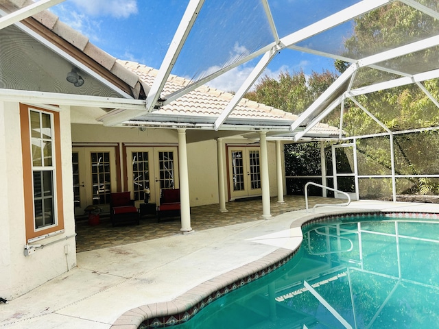 view of pool featuring french doors, glass enclosure, and a patio