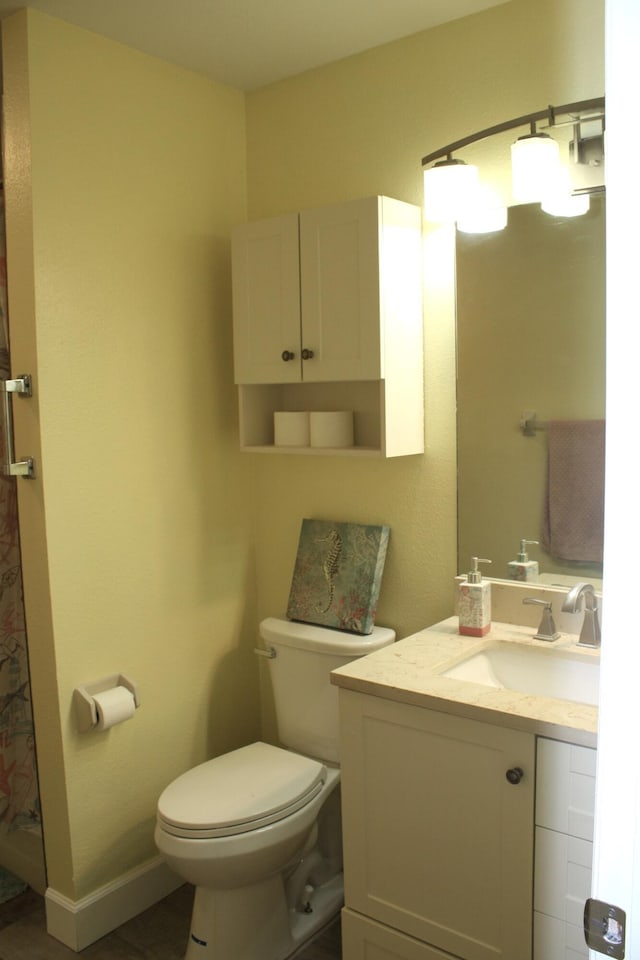 bathroom with tile patterned floors, vanity, and toilet