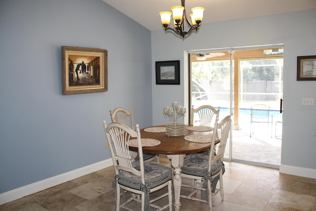 dining space featuring a chandelier and lofted ceiling