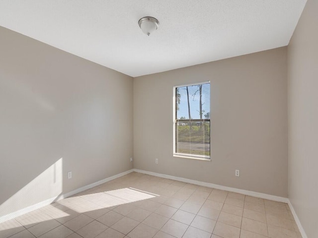 spare room featuring light tile patterned floors